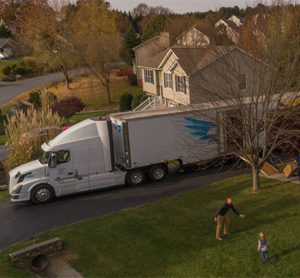 House with a United Van Lines moving truck in the driveway.