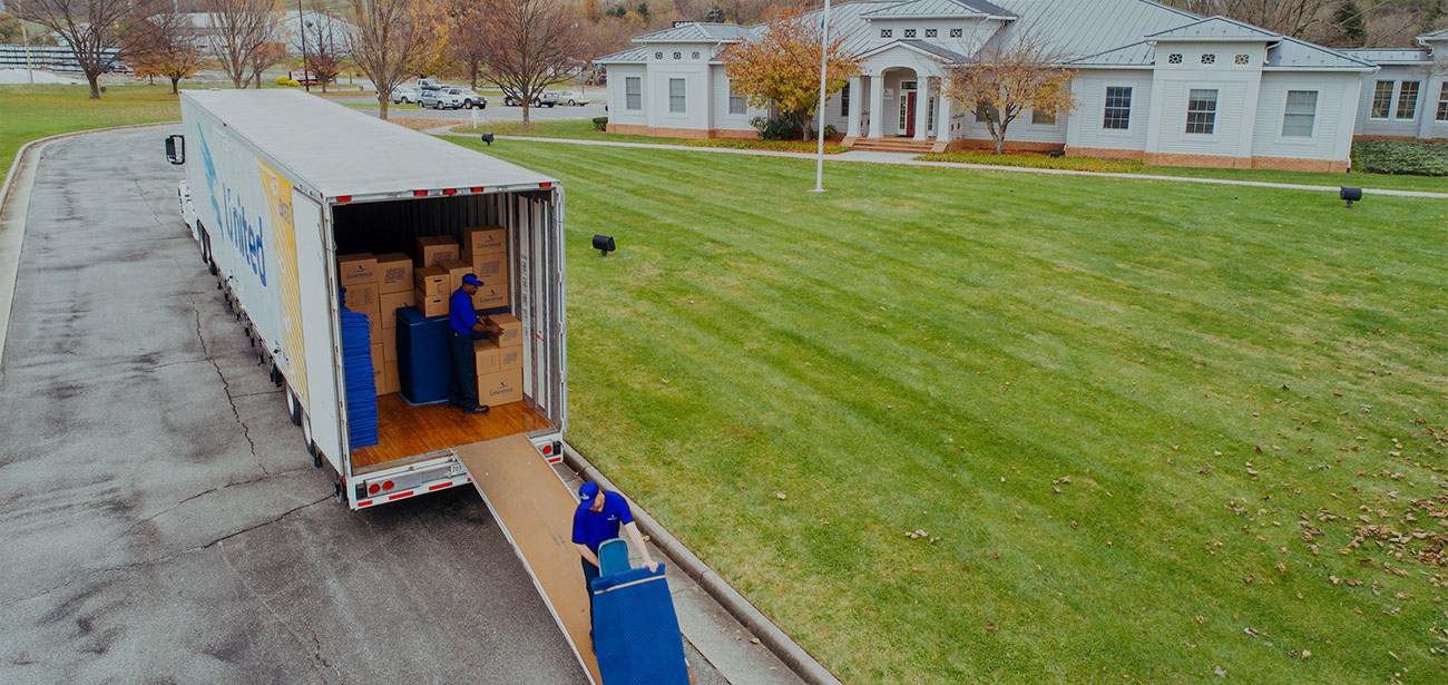 Two movers unloading a truck.