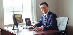 A business man sitting at his desk.