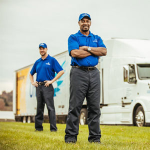 Two movers standing in front of a United Van Lines moving truck.