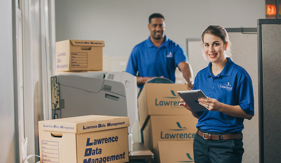 Data Management employees evaluate an office.