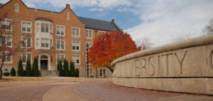 A college university with a building in the background.