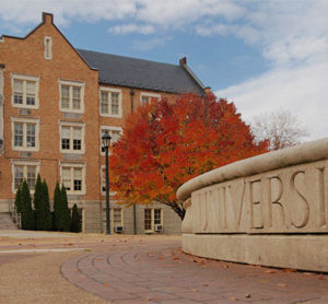 A college university with a building in the background.