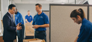 A commercial mover talking to a man in a suit.