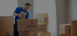 A man holding a table looks over some boxes.