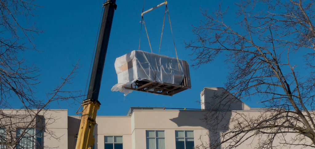 A crane lifting a large piece of machinery