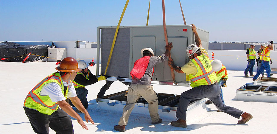 Workers rigging a piece of equipment