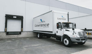 A Lawrence Moving truck backed up to a loading dock.
