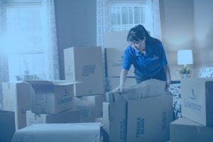 moving woman packing boxes for residential move