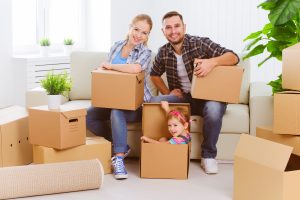 moving to a new home. Happy family with cardboard boxes