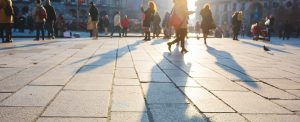 Pedestrian out of focus walking on sidewalk in the city center of a metropolis - rush hour, commuters, walking concept