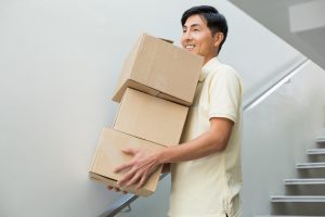 Man carrying moving boxes down steps