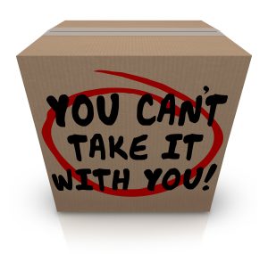 A Moving box with the words "You Can't Take It With You" written in black marker on it.