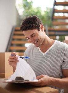 Man prepparing to move reviewing a list on clipboard